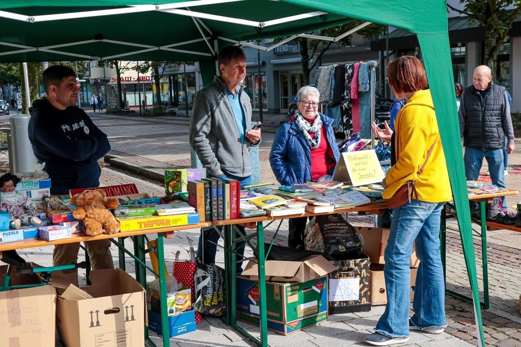 Menschen stehen auf dem Marktplatz für das Foto